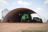 an Metal Barn Building Kits for Agriculture example with a green tractor pictured inside the building