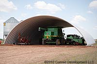 an Metal Barn Building Kits for Agriculture example with a green tractor pictured inside the building