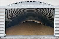 a metal round top building being used to store grain 