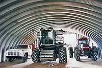a prefabricated metal building being used for farm equipment storage