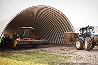 Tractors in farm equipment storage steel building 