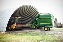 an arch building protecting a tractor underneath 