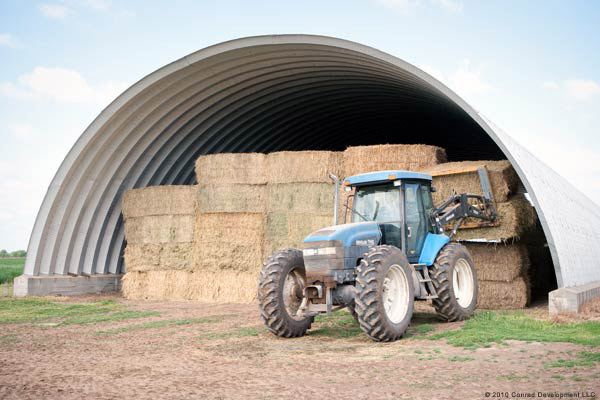 a steel building with hay inside