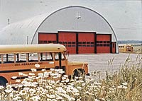 a round top building with red doors