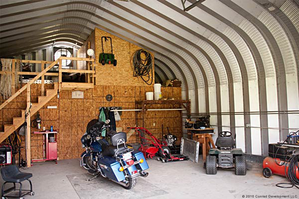 inside view of a small shop with a motorcycle stored inside 